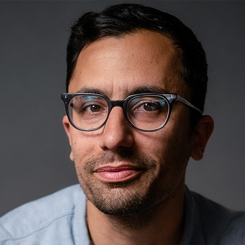 headshot of man in photo studio with medium warm skin tone and brown eyes